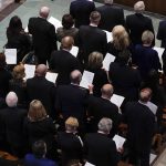 
              People attend the funeral service for former Sen. Bob Dole of Kansas, at the Washington National Cathedral, Friday, Dec. 10, 2021, in Washington. (AP Photo/Evan Vucci)
            