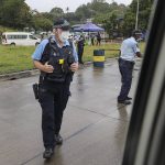 
              Solomon Islands police and Australian Federal Police patrol road blocks in Honiara, Solomon Islands, Monday, Dec. 6, 2021. Lawmakers in the Solomon Islands are debating whether they still have confidence in the prime minister, after rioters last month set fire to buildings and looted stores in the capital. (Gary Ramage via AP)
            