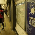 
              A commuter walks past a TFL (Transport for London)  information poster telling passengers that it is compulsory to wear a face mask on public transport to curb the spread of COVID-19, in London, Tuesday, Nov. 30, 2021. The emergence of the new COVID-19 omicron variant and the world's desperate and likely futile attempts to keep it at bay are reminders of what scientists have warned for months: The coronavirus will thrive as long as vast parts of the world lack vaccines.(AP Photo/Alastair Grant)
            