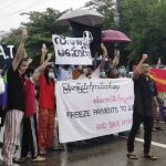 
              In this image made from a video provided by the Youth Association of Thingangyun, protesters hold signs in Yangon on Oct. 30, 2021, calling for the freezing of revenues from oil and gas sales in Myanmar. As the military's abuses have grown after seizing power in February, people from Myanmar's southern jungles to its northern mountains are voicing support for targeted sanctions on oil and gas funds, the country's single largest source of foreign currency revenue. (Courtesy of the Youth Association of Thingangyun via AP)
            