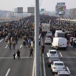 
              Protesters stand on the highway during a protest in Belgrade, Serbia, Saturday, Dec. 4, 2021. Thousands of protesters have gathered in Belgrade and other Serbian towns and villages to block roads and bridges despite police warnings and an intimidation campaign launched by authorities against the participants. Thousands of protesters have gathered in Belgrade and other Serbian towns and villages to block roads and bridges despite police warnings and an intimidation campaign launched by authorities against the participants. (AP Photo/Darko Vojinovic)
            