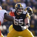 
              Iowa offensive lineman Tyler Linderbaum (65) looks to make a block during the first half of an NCAA college football game against Illinois, Nov. 20, 2021, in Iowa City, Iowa. (AP Photo/Charlie Neibergall)
            