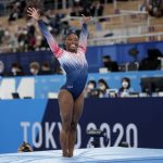 
              FILE - Simone Biles, of the United States, finishes on the balance beam during the artistic gymnastics women's apparatus final at the 2020 Summer Olympics, Tuesday, Aug. 3, 2021, in Tokyo, Japan. Biles’ 2021 experiences, and how she talked about them, helped drive a robust conversation about athletes’ emotional health. (AP Photo/Ashley Landis, File)
            