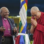 
              FILE - Anglican Archbishop Emeritus Desmond Tutu, left, holds a microphone as Tibetan spiritual leader the Dalai Lama gestures, as they interact with children at the Tibetan Children's Village School in Dharmsala, India, Thursday, April 23, 2015. Tutu, South Africa’s Nobel Peace Prize-winning activist for racial justice and LGBT rights and retired Anglican Archbishop of Cape Town, has died, South African President Cyril Ramaphosa announced Sunday Dec. 26, 2021. He was 90. (AP Photo/Ashwini Bhatia, File)
            