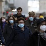 
              FILE - People wearing face masks to curb the spread of COVID-19 walk in downtown Lisbon, Monday, Nov. 29, 2021. A pandemic-weary world faces weeks of confusing uncertainty as countries restrict travel and take other steps to halt the newest potentially risky coronavirus mutant before anyone knows just how dangerous omicron really is. (AP Photo/Ana Brigida, File)
            