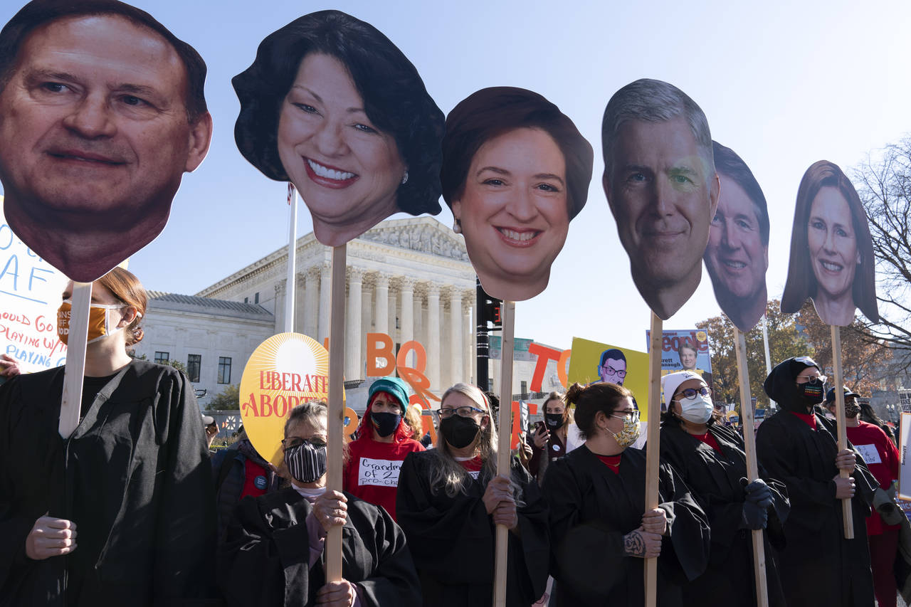 Abortion rights advocates holding cardboard cutouts of the Supreme Court Justices, demonstrate in f...