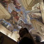 
              Princess Rita Boncompagni Ludovisi shows a fresco by Guercino inside The Casino dell’Aurora, also known as Villa Ludovisi, in Rome, Tuesday, Nov. 30, 2021. The villa in the heart of Rome that features the only known ceiling painted by Caravaggio is being put up for auction by court order after the home was restored by its last occupants: a Texas-born princess and her late husband, a member of one of Rome’s aristocratic families. (AP Photo/Gregorio Borgia)
            