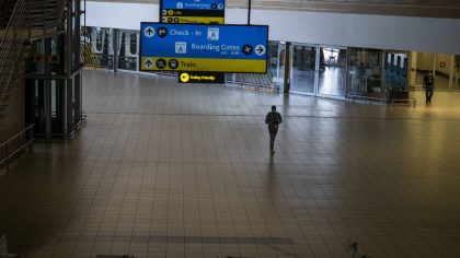 FILE - A man walks through a deserted part of Johannesburg's OR Tambo's airport, South Africa, Mond...