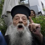 
              A protesting Orthodox Priest shouts against the visit of Pope Francis at the Archbishopric of Greece in Athens, Saturday, Dec. 4, 2021. Pope Francis warned Saturday that the "easy answers" of populism and authoritarianism threaten democracy in Europe and called for fresh dedication to promoting the common good. (AP Photo/Michael Varaklas)
            