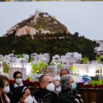 
              Members of the Greece religious community sit in front of a giant poster of Athen's landmark Mt. Lycabettus during a meeting with Pope Francis at the St. Dionysius Cathedral in Athens, Greece, Saturday, Dec. 04, 2021. Pope Francis arrived in Athens on Saturday for the second leg of a five-day visit to Cyprus and Greece aimed at bolstering recently mended ties between the Vatican and Greek Orthodox churches. (AP Photo/Alessandra Tarantino)
            
