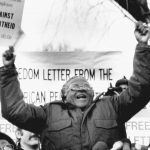 
              FILE - South African Bishop Desmond Tutu waves during a speech against apartheid,  to a crowd of demonstrators, on Jan. 8, 1986, outside the South African Embassy in Washington. South Africa’s Nobel Peace Prize-winning activist for racial justice and LGBT rights and the retired Anglican Archbishop of Cape Town, has died at the age of 90, it was announced on Sunday, Dec. 26, 2021. An uncompromising foe of apartheid, South Africa’s brutal regime of oppression again the Black majority, Tutu worked tirelessly, but non-violently, for its downfall. (AP Photo/Dennis Cook, File)
            