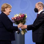 
              New elected German Chancellor Olaf Scholz, right, gives flowers to former Chancellor Angela Merkel during a handover ceremony in the chancellery in Berlin, Wednesday, Dec. 8, 2021. (Photo/Markus Schreiber)
            