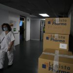 
              A medical worker walks past covid kit boxes in the Wizink Center, currently used for COVID-19 vaccinations in Madrid, Spain, Wednesday, Dec. 1, 2021. Health authorities in the Spanish capital have confirmed a second case of the omicron coronavirus variant in a 61-year-old woman who had returned from a trip to South Africa on Monday. (AP Photo/Paul White)
            