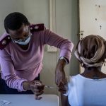 
              A woman is vaccinated against COVID-19 in Lawley, south of Johannesburg, South Africa, Wednesday, Dec. 1, 2021. Scientists say it could be weeks before they better understand how dangerous the omicron variant is. (AP Photo/ Shiraaz Mohamed)
            