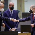 
              Slovenia's Prime Minister Janez Jansa, left, greets German Chancellor Olaf Scholz, right, during a round table meeting at an EU Summit in Brussels, Thursday, Dec. 16, 2021. European Union leaders meet for a one-day summit Thursday that will center on Russia's military threat to neighbouring Ukraine and on ways to deal with the continuing COVID-19 crisis. (Olivier Hoslet, Pool Photo via AP)
            