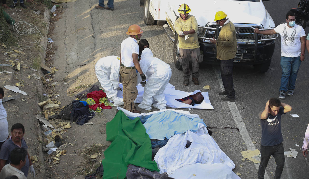 Bodies in bodybags are placed on the side of the road after an accident in Tuxtla Gutierrez, Chiapa...
