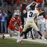 
              FILE - Purdue receiver David Bell, right, catches a pass in front of Ohio State defensive back Denzel Burke during the second half of an NCAA college football game, Nov. 13, 2021, in Columbus, Ohio. (AP Photo/Jay LaPrete, File)
            