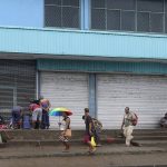 
              Locals gather outside closed shops in Honiara, Solomon Islands, Monday, Dec. 6, 2021. Lawmakers in the Solomon Islands are debating whether they still have confidence in the prime minister, after rioters last month set fire to buildings and looted stores in the capital.(Gary Ramage via AP)
            