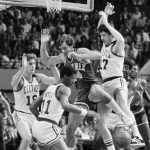 
              FILE - Boston's Dave Cowens, left, Charlie Scott (11) and John Havlicek team up on Paul Westphal, of the Phoenix Suns, as they try to go for a rebound during the first period of an NBA championship game at the Boston Garden, June 4, 1976. The longest game yet at the NBA Finals happened between the Boston Celtics and Phoenix Suns with the series tied at 2 apiece. (AP Photo/Peter Southwick, File)
            
