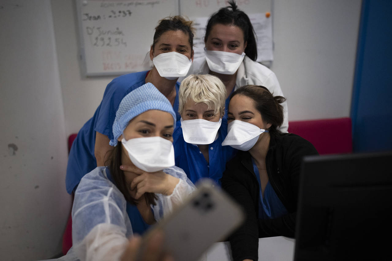 Hospital workers pose for a selfie together in the COVID-19 intensive care unit of the la Timone ho...