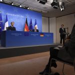
              French President Emmanuel Macron, left, and German Chancellor Olaf Scholz, center, address a media conference at the conclusion of an EU Summit in Brussels, Friday, Dec. 17, 2021. European Union leaders met for a one-day summit Thursday focusing on Russia's military threat to neighbouring Ukraine and on ways to deal with the continuing COVID-19 crisis. (John Thys, Pool Photo via AP)
            