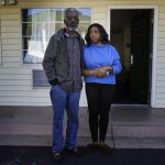 
              Faye Moore and her partner Garry Betared pose for a portrait outside a hotel room they are staying in following their eviction from Moore's two-bedroom townhouse on Wednesday, Nov. 24, 2021, in Morrow, Ga. Housing advocates say evictions are increasing around the country, several months after a federal moratorium was allowed to end.  (AP Photo/Brynn Anderson)
            