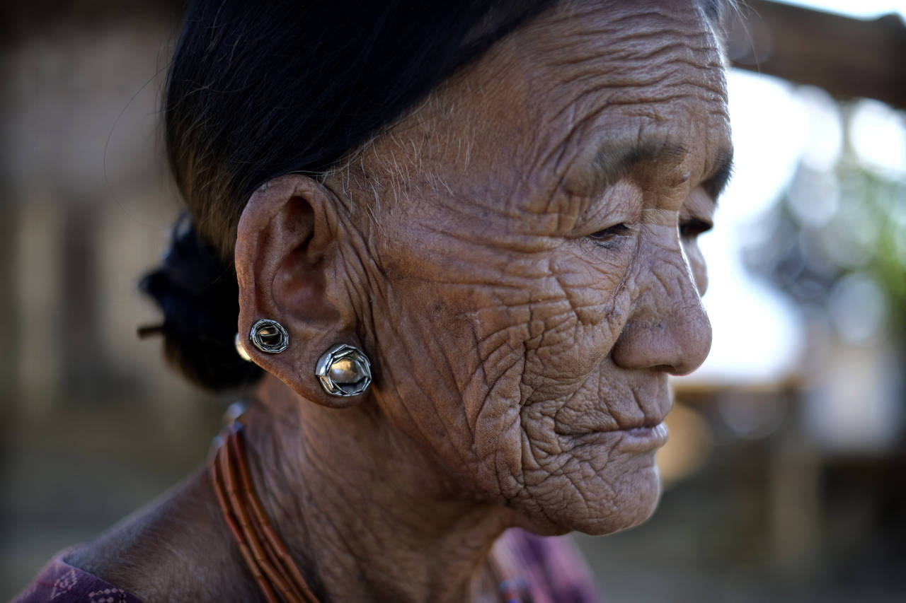 Nguntoi Konyak, 85,  sits outside her home in Oting village, in the northeastern Indian state of Na...