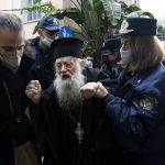 
              Police hold a protesting Orthodox Priest during the visit of Pope Francis at the Archbishopric of Greece in Athens, Saturday, Dec. 4, 2021. Pope Francis warned Saturday that the "easy answers" of populism and authoritarianism threaten democracy in Europe and called for fresh dedication to promoting the common good. (AP Photo/Michael Varaklas)
            