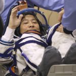 
              In this photo released by the Roscosmos Space Agency, spaceflight participant Yusaku Maezawa of Japan, member of the main crew of the new Soyuz mission to the International Space Station (ISS) gestures during inspecting his space suit prior the launch at the Russian leased Baikonur cosmodrome, Kazakhstan, Wednesday, Dec. 8, 2021. (Pavel Kassin, Roscosmos Space Agency via AP)
            