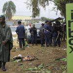 
              Police officers inspect the scene of a bombed explosion in Beni, eastern Congo Sunday Dec. 26, 2021. A bomb exploded at a restaurant Saturday as patrons gathered on Christmas Day in an eastern Congolese town where Islamic extremists are known to be active. (AP Photo/Al-hadji Kudra Maliro)
            