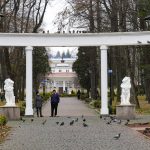 People walk in a city park that hosts a spa sanatorium in Morshyn, Ukraine, Tuesday, Nov. 16, 2021. In Morshyn, a scenic town nestled at the Carparthian foothills in the Lviv region, 74% of 3,439 residents have been fully vaccinated. A small spa town in western Ukraine stands out in a country where just under a quarter of the population has received coronavirus vaccines. (AP Photo/Efrem Lukatsky)