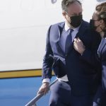 FILE - Vice President Kamala Harris and her husband, Doug Emhoff, walk off Air Force Two on arrival to Los Angeles, on March 15, 2021. (AP Photo/Jacquelyn Martin, File)