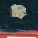 
              FILE- Mars rock Allan Hills 84001, discovered in 1984, is shown at a NASA news conference, Aug. 7, 1996, in Washington. Scientists say they've confirmed the meteorite from Mars contains no evidence of ancient Martian life. The rock caused a splash 25 years ago when a NASA-led team announced that its organic compounds may have been left by living creatures, however primitive. Researchers chipped away at that theory over the decades. A team of scientists led by Andrew Steele of the Carnegie Institution published their findings Thursday, Jan. 13, 2022. (AP Photo/Doug Mills, file)
            