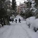 
              People walk in Cholargos suburb of Athens after a snowstorm, on Tuesday, Jan. 25, 2022. A snowstorm of rare severity disrupted road and air traffic Monday in the Greek capital of Athens and neighboring Turkey's largest city of Istanbul, while most of Greece, including — unusually — several Aegean islands, and much of Turkey were blanketed by snow. (AP Photo/Michael Varaklas)
            