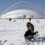 
              People enjoy snow at the Olympic complex in northern Athens, Greece, Wednesday, Jan. 26, 2022. Greek authorities struggle to clear blocked roads and restore power to blacked out parts of the Greek capital after heavy snowfall has caused major disruptions in Greece. (AP Photo/Thanassis Stavrakis)
            