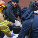 
              Emergency personnel perform CPR on a fire victim during a high rise fire on East 181 Street, Sunday, Jan. 9, 2022, in the Bronx borough of New York. (AP Photo/Lloyd Mitchell)
            