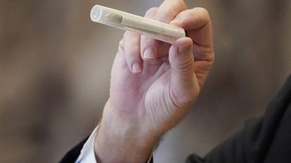 State Sen. Kevin Blackwell, R-Southaven, lead negotiator, holds a tube containing a cigarette and a...
