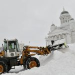 
              A snow plough works to remove snow at the Senate Square near the Helsinki Cathedral, in Helsinki, Sunday Jan. 30, 2022. A winter storm brought heavy winds and snow on Saturday and Sunday to Finland. (Heikki Saukkomaa/Lehtikuva via AP)
            