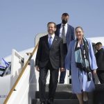 
              In this photo provided by the Israeli Government Press Office, Israeli President Isaac Herzog and First Lady Michal Herzog arrive to Abu Dhabi, United Arab Emirates,, Sunday, Jan. 30, 2022. Israel's president arrived in the United Arab Emirates on Sunday in the first official visit by the country's head of state, the latest sign of deepening ties between the two nations as tensions rise in the region. (Amos Ben Gershom/GPO via AP)
            