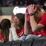 
              Fans at the University of Georgia's coliseum in Athens, Ga., hold their heads after Alabama converted a first down during the second half of the College Football Playoff championship game Monday, Jan. 10, 2022. (AP Photo/Ben Gray)
            
