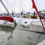 
              A damaged boat is partially submerged in a marina at Tutukaka, New Zealand, Sunday, Jan. 16, 2022, after waves from a volcano eruption swept into the marina. An undersea volcano erupted in spectacular fashion Saturday near the Pacific nation of Tonga, sending tsunami waves crashing across the shore and people rushing to higher ground. (Tanya White/Northern Advcate/NZME via AP)
            