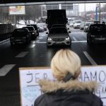 
              A demonstrator blocks a highway, during a protest in Belgrade, Serbia, Saturday, Jan. 15, 2022. Hundreds of environmental protesters demanding cancelation of any plans for lithium mining in Serbia took to the streets again, blocking roads and, for the first time, a border crossing. Traffic on the main highway north-south highway was halted on Saturday for more than one hour, along with several other roads throughout the country, including one on the border with Bosnia. (AP Photo/Darko Vojinovic)
            