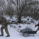 
              Ukrainian servicemen carry water supplies for an advanced position on the front line in the Luhansk area, eastern Ukraine, Thursday, Jan. 27, 2022. The U.S. rejection of Russia's main demands to resolve the crisis over Ukraine left "little ground for optimism," the Kremlin said Thursday, but added that dialogue was still possible. (AP Photo/Vadim Ghirda)
            