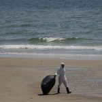 
              Workers carry out a cleanup operation on Mae Ramphueng Beach after a pipeline oil spill off the coast of Rayong province in eastern Thailand, Sunday, Jan. 30, 2022. The governor of a province in eastern Thailand on Saturday declared a state of emergency after an oil slick washed up on a sand beach, shutting down restaurants and shops in a setback for the pandemic-hit tourism industry. (AP Photo/Sakchai Lalit)
            