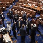 
              FILE - U.S. Capitol Police officials meet on the floor of the House Chamber after rioters tried to break into the chamber at the Capitol in Washington, Wednesday, Jan. 6, 2021. (AP Photo/J. Scott Applewhite, File)
            