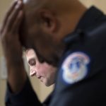 
              FILE - U.S. Capitol Police Sgt. Harry Dunn listens as Washington Metropolitan Police Department officer Daniel Hodges testifies before the House select committee hearing on the Jan. 6 attack on Capitol Hill in Washington, July 27, 2021. (Brendan Smialowski/Pool via AP, File)
            