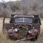 
              A truck rest in a field near the Wyman Museum on Friday, Nov. 19, 2021, in Craig, Colo. The town in northwest Colorado is losing its coal plant, and residents fear it is the beginning of the end for their community. (AP Photo/Rick Bowmer)
            