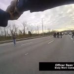 This still image from police body cam released by Metropolitan Nashville Police Department shows officers pleading with a man to surrender before shooting him on Jan. 28, 2022 in Nashville, Tenn. Tennessee police officers repeatedly pleaded with a man who stopped traffic along Interstate 65 to drop a box cutter and surrender, saying no one wanted to hurt him. Instead, he abruptly pulled another shiny object from his pocket and pointed it at police as if ready to shoot, prompting nine of the officers who surrounded him at gunpoint to open fire, killing him on the highway, according to officials and body camera video. (Metropolitan Nashville Police Department via AP)
