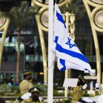 
              An Emirati honor guard raises the Israeli flag ahead of a speech by Israeli President Isaac Herzog at Expo 2020 in Dubai, United Arab Emirates, Monday, Jan. 31, 2022. The UAE intercepted a ballistic missile fired by Yemen's Houthi rebels early Monday as the Israeli president visited the country, authorities said, the third such attack in recent weeks. (AP Photo/Jon Gambrell)
            