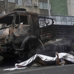
              A body of victim laying near a military truck, which was burned after clashes, is seen in Almaty, Kazakhstan, Thursday, Jan. 6, 2022. Kazakhstan's president authorized security forces on Friday to shoot to kill those participating in unrest, opening the door for a dramatic escalation in a crackdown on anti-government protests that have turned violent. The Central Asian nation this week experienced its worst street protests since gaining independence from the Soviet Union three decades ago, and dozens have been killed in the tumult. (Vladimir Tretyakov/NUR.KZ via AP)
            